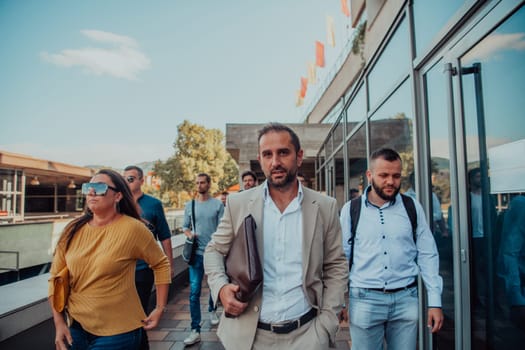 A diverse group of businessmen and colleagues walking together by their workplace, showcasing collaboration and teamwork in the company