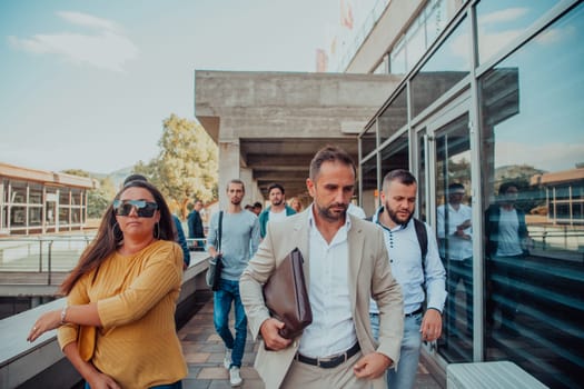 A diverse group of businessmen and colleagues walking together by their workplace, showcasing collaboration and teamwork in the company