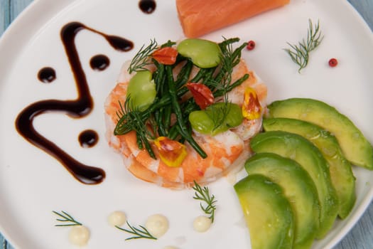 Recipe Fish Appetizer shrimp carpaccio, smoked salmon, avocado, samphire, broad beans, lemon sauce, olive oil, served with mayonnaise in white round plate, High quality photo