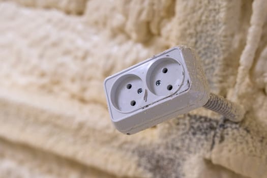 Electrical outlet hanging on a wire in the workshop. Industrial socket attached to the wall of the workshop. copy space