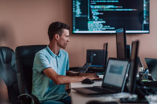 A programmer diligently testing smartphone applications while sitting in their office. High quality photo