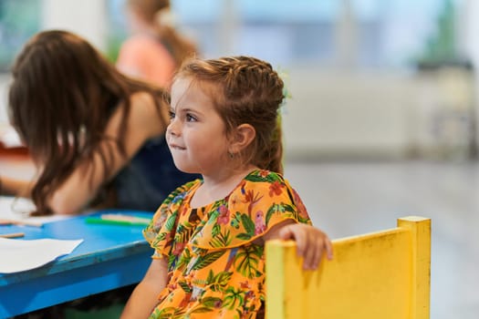 Creative kids sitting in a preschool institution, draw and have fun while they get an education. High quality photo