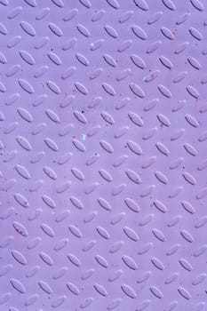 The background of the corrugated iron sheet is purple. Textured abstract purple background with copy space. Vertical photo