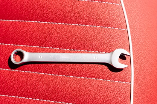 a wrench on the leather seat of a motorcycle during repair. High quality photo