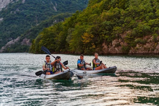 A group of friends enjoying having fun and kayaking while exploring the calm river, surrounding forest and large natural river canyons.