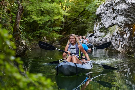 A group of friends enjoying having fun and kayaking while exploring the calm river, surrounding forest and large natural river canyons.