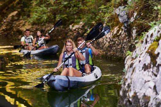 A group of friends enjoying having fun and kayaking while exploring the calm river, surrounding forest and large natural river canyons.