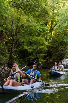 A group of friends enjoying having fun and kayaking while exploring the calm river, surrounding forest and large natural river canyons.