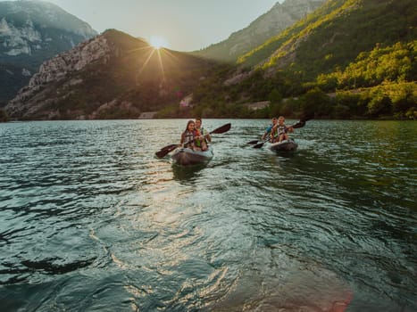 A group of friends enjoying fun and kayaking exploring the calm river, surrounding forest and large natural river canyons during an idyllic sunset