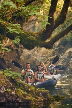 A group of friends enjoying having fun and kayaking while exploring the calm river, surrounding forest and large natural river canyons.