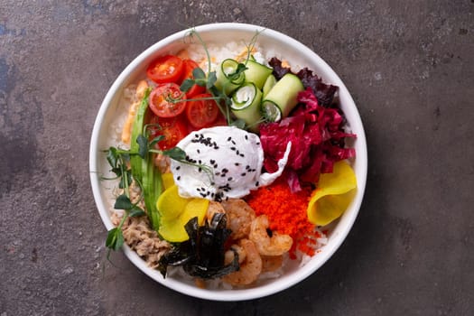 top view salad bowl with egg and shrimp, avocado, tobiko and other ingredients.