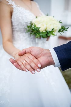 Newlyweds on wedding day, wedding couple holding hands, bride and groom
