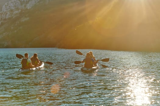 A group of friends enjoying fun and kayaking exploring the calm river, surrounding forest and large natural river canyons during an idyllic sunset