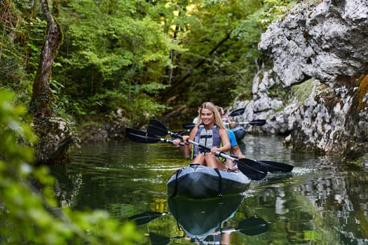 A young couple enjoying an idyllic kayak ride in the middle of a beautiful river surrounded by forest greenery.