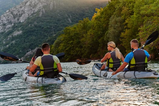 A group of friends enjoying having fun and kayaking while exploring the calm river, surrounding forest and large natural river canyons.