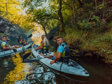 A group of friends enjoying having fun and kayaking while exploring the calm river, surrounding forest and large natural river canyons.