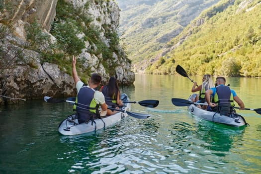 A group of friends enjoying having fun and kayaking while exploring the calm river, surrounding forest and large natural river canyons.