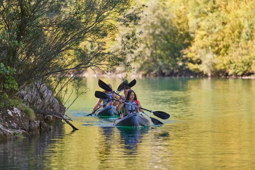 A group of friends enjoying having fun and kayaking while exploring the calm river, surrounding forest and large natural river canyons.