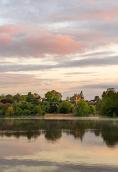 Sunset view of town of Ellesmere in Shropshire with reflection view across the Mere to the Church
