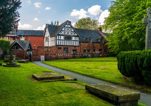 Oswestry, Shropshire - 12 May 2023: Half timbered Old School House in cemetery in market town of Oswestry