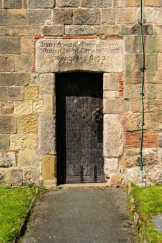 Old wooden door in church tower of St Oswalds parish church in market town of Oswestry