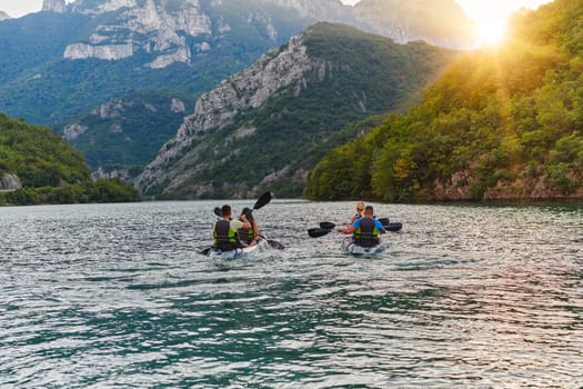 A group of friends enjoying fun and kayaking exploring the calm river, surrounding forest and large natural river canyons during an idyllic sunset