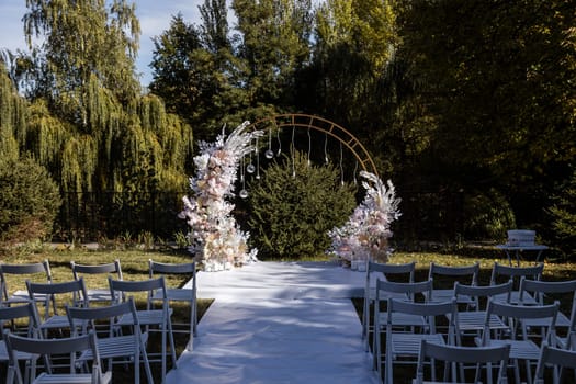 Festive arch for the ceremony of painting the newlyweds on the wedding day, wedding decor with fresh flowers