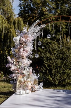 Festive arch for the ceremony of painting the newlyweds on the wedding day, wedding decor with fresh flowers