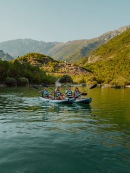 A group of friends enjoying having fun and kayaking while exploring the calm river, surrounding forest and large natural river canyons.