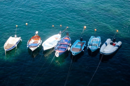 Photographic documentation of small fishing boats moored in port 