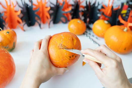 Halloween October 31st. The step-by-step process of carving a pumpkin. View from above