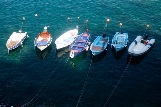 Photographic documentation of small fishing boats moored in port 