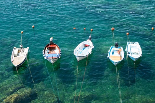 Photographic documentation of small fishing boats moored in port 
