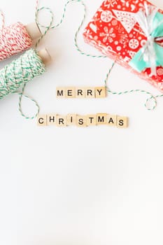 Concept of holiday for Christmas and New Year 2023-2024. Schedule of various Christmas attributes - striped threads for wrapping, gift wrapping. Merry Christmas lettering