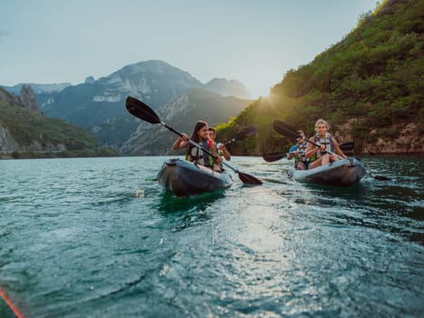 A group of friends enjoying fun and kayaking exploring the calm river, surrounding forest and large natural river canyons during an idyllic sunset