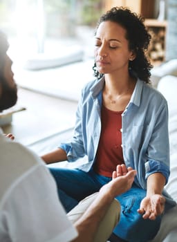 Couple, meditation and spiritual wellness on sofa for mental health, zen or workout in living room together at home. Man and woman yogi in relax, meditate or yoga class on couch for peaceful mind.