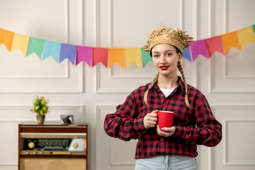 festa junina cute girl in straw hat brazilian midsummer with retro radio colorful flags holding cup