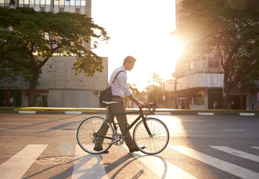 Commute, bike and business man in city for morning, travel and carbon footprint. Cycling, transportation and urban with male employee walking on crosswalk for journey, transit and professional.
