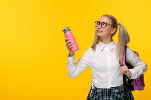 world book day blonde school girl holding pink flask and backpack