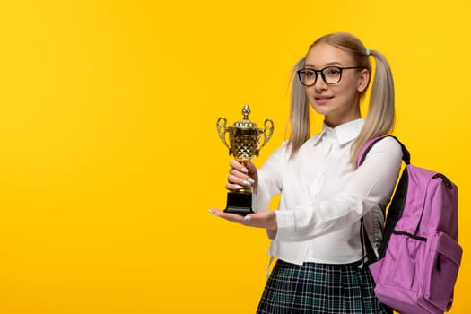 world book day blonde cute school girl in uniform holding a price