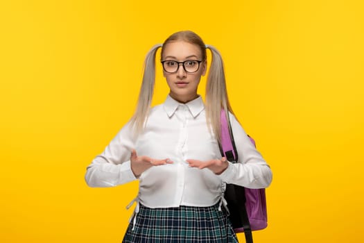 world book day blonde girl with pony tails in glasses