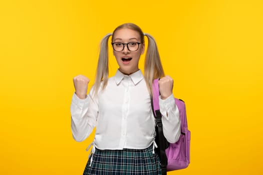world book day blonde girl with ponytails and pink backpack in uniform