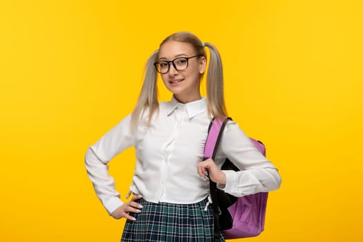 world book day blonde schoolgirl in school uniform with pink backpack