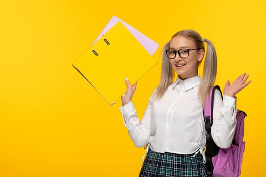 world book day blonde smiling school girl with folders and backpack