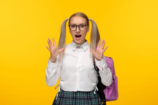 world book day excited blonde school girl with waving hands in uniform
