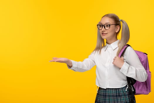 world book day girl with ponytails blonde pointing left in glasses