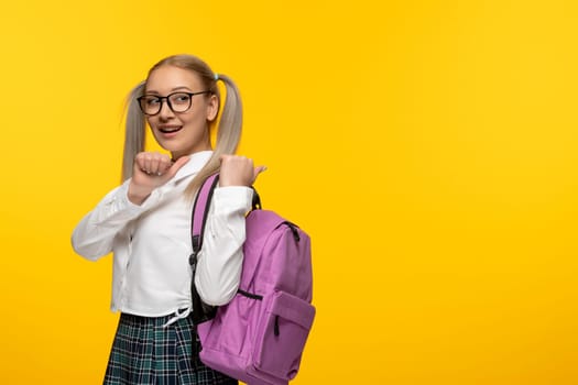 world book day happy school girl with pink backpack looking behind