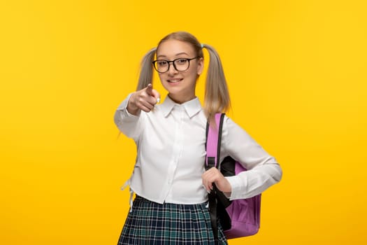 world book day happy schoolgirl in cute uniform checked skirt with pink backpack
