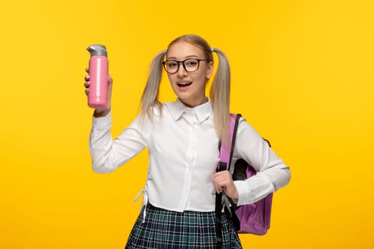 world book day happy schoolgirl in cute uniform with backpack and thermos
