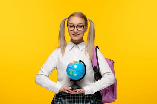 world book day smiling adorable school girl with backpack holding a globus